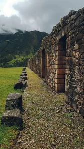 stone ruins of choquequirao with mountains in the background on a cloudy day